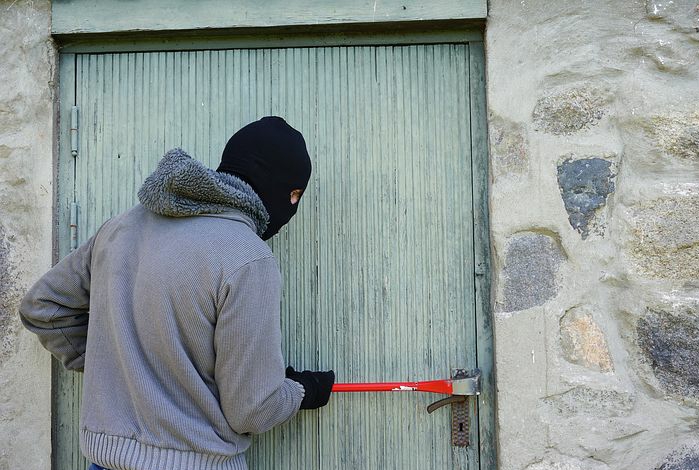 A thief breaking into a house