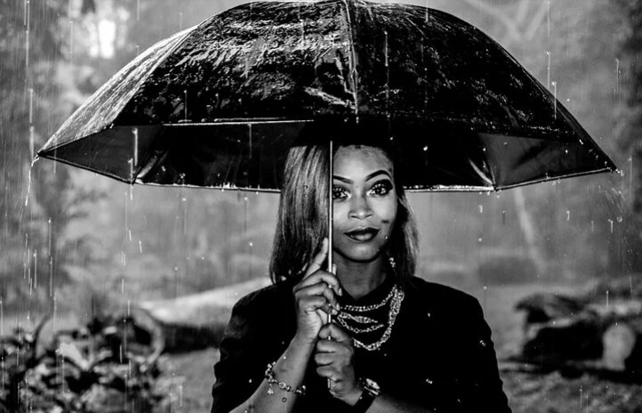 A woman in the story of faith holding umbrella