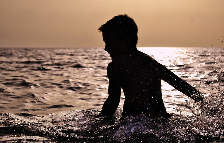 A boy enjoying nature by swimming 