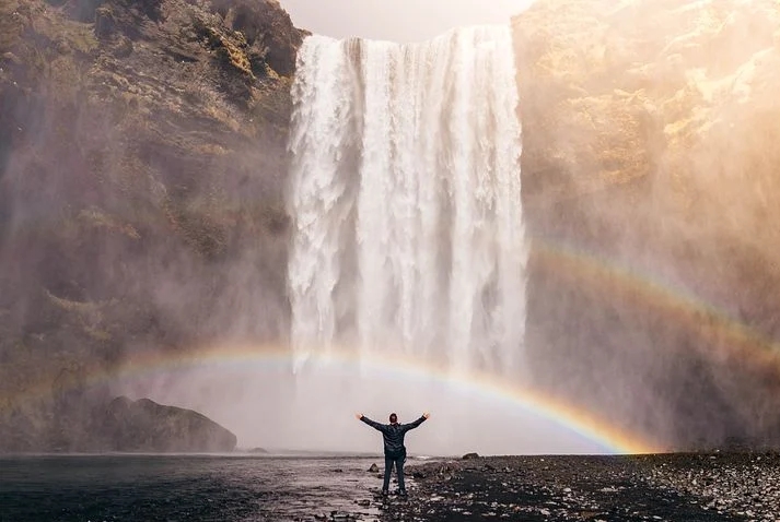 A man standing close to Stream water 