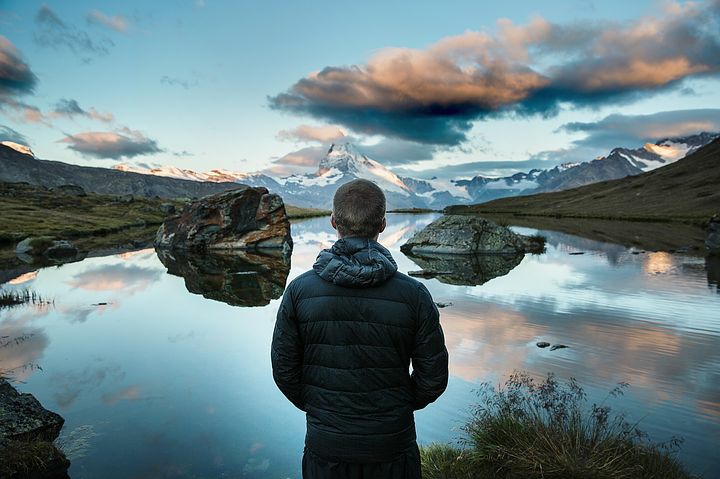 A man standing still an gazing at the sky 