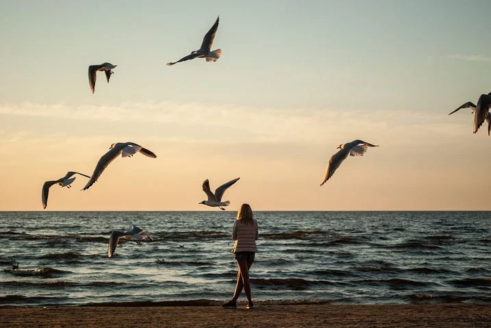 A woman at the beach feeling hopeful